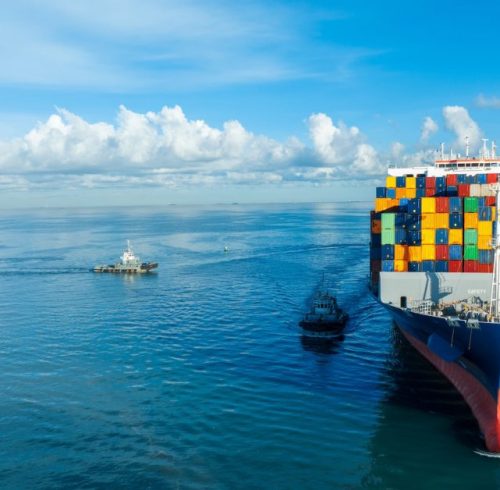 front-view-contaier-cargo-ship-import-export-container-box-on-the-ocean-sea-on-blue-sky.jpg